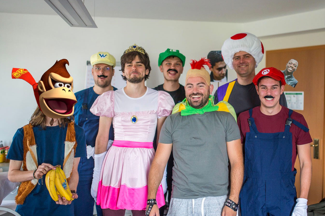 Transloadit teammates in costumes from the Super Mario Bros. universe