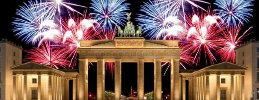 The Brandenburg Gate with fireworks lighting up the sky behind it