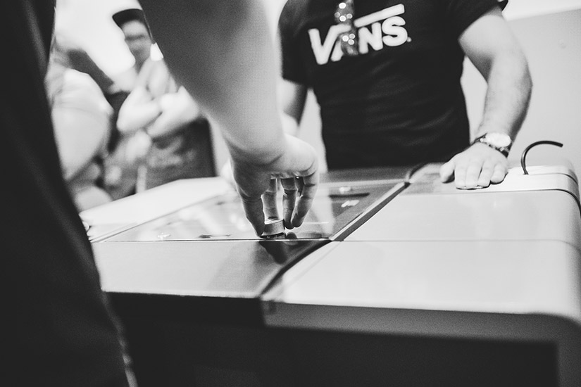 Black and white photo of two team members in a fierce game of Pong.