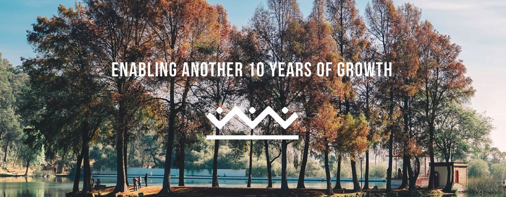 Photo of a wooded area with the text 'Enabling another 10 years of growth' in front