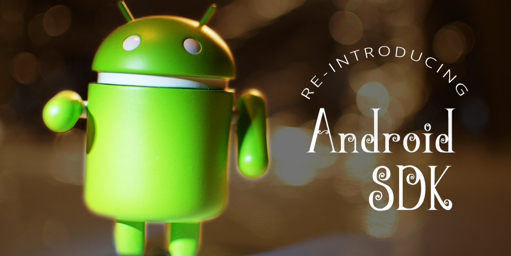 The Android robot pointing at the camera with the text 'Reintroducing the Android SDK' on the right.